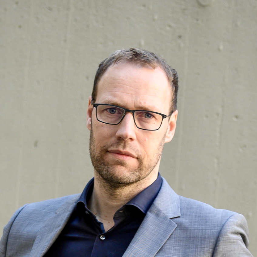 Author photo of Diederik Oostdijk. He is a white man with short brown hair and dark rim glasses. 