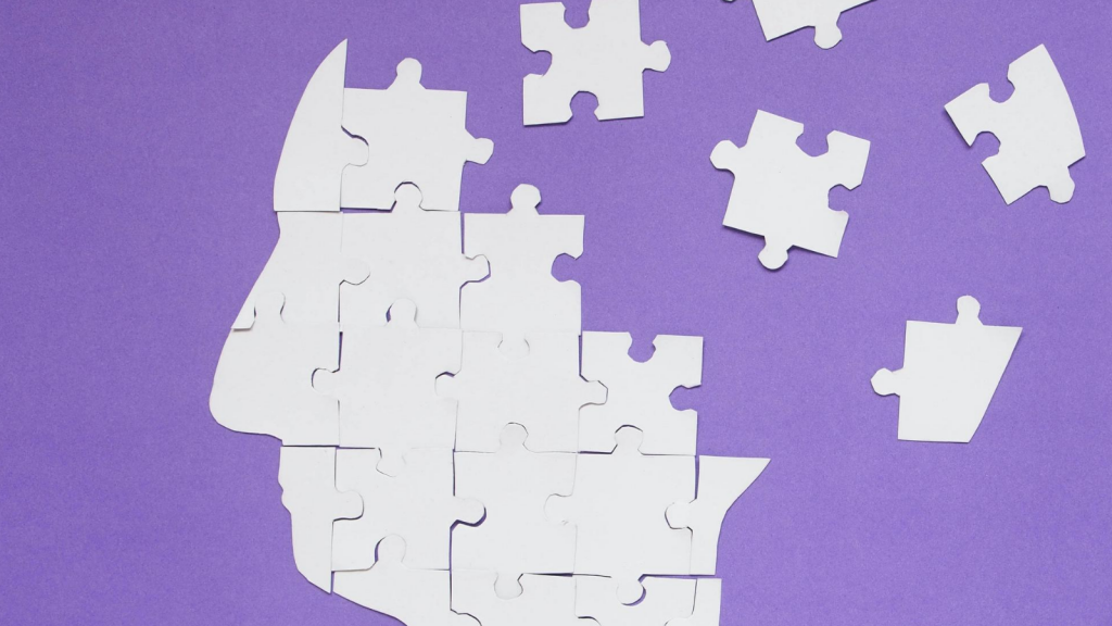 white puzzle pieces, some together, some not, against a purple background